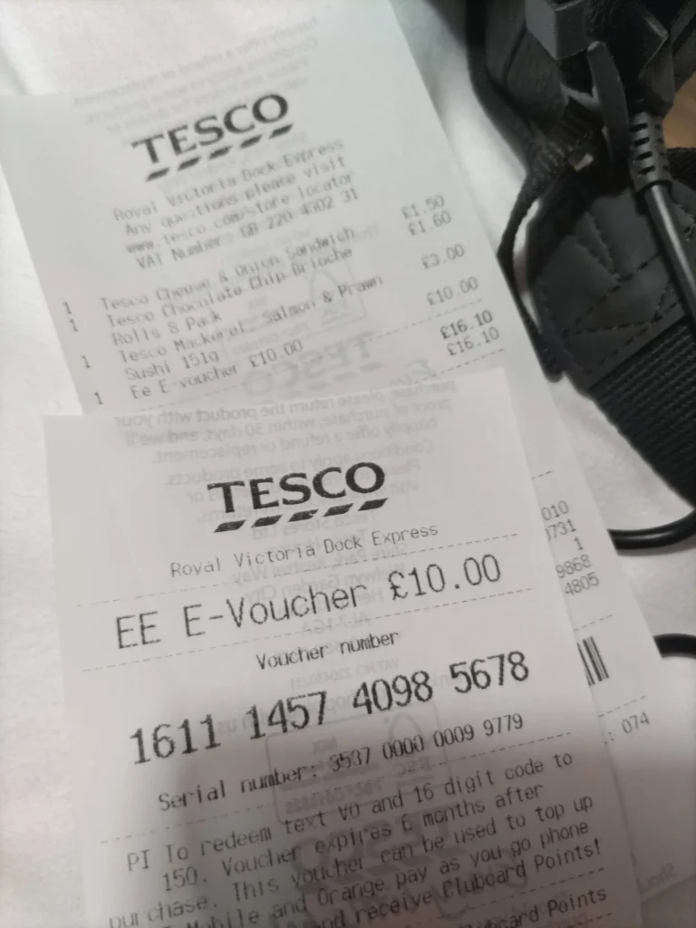 "EE E-Voucher £10.00"と16桁のVoucher numberが書かれた紙